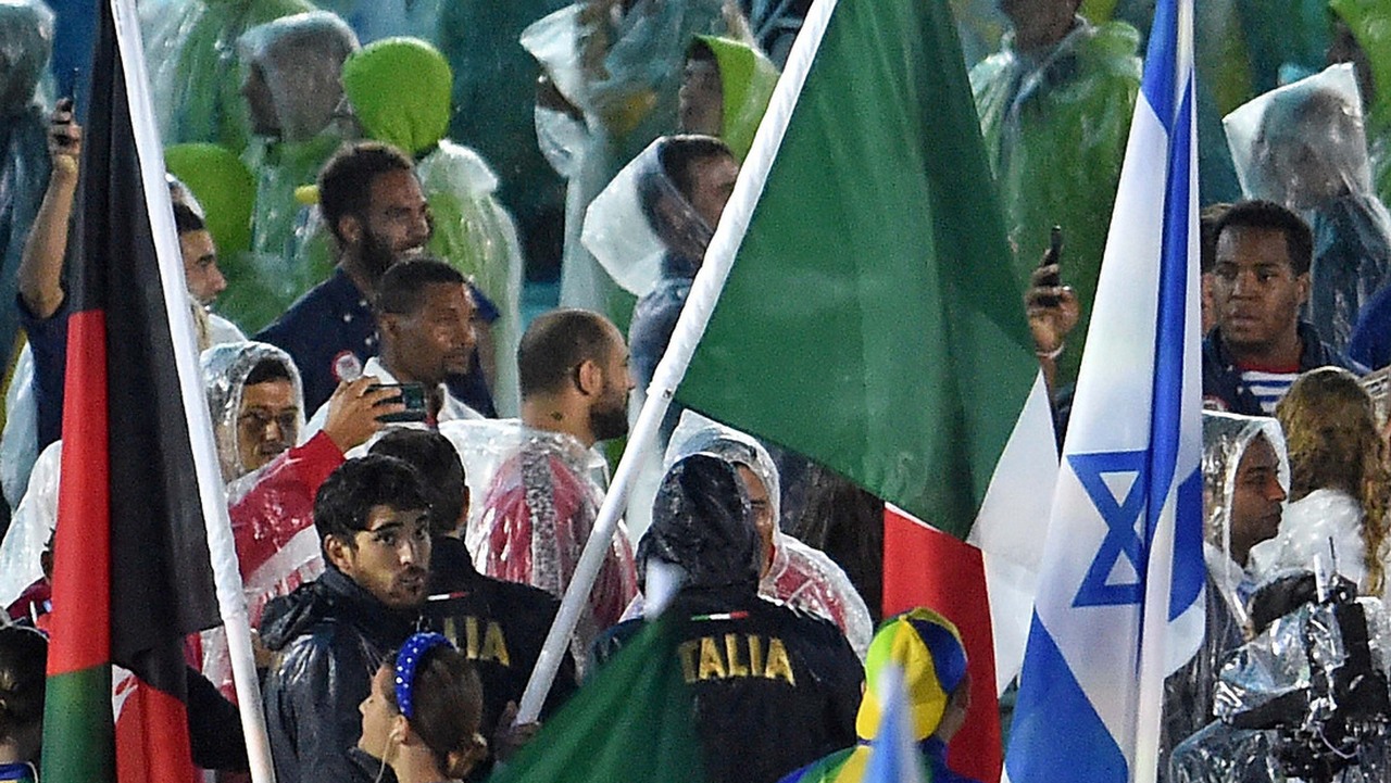 Lupo carries the Italian flag during the closing ceremony. See you in Tokyo in 2020